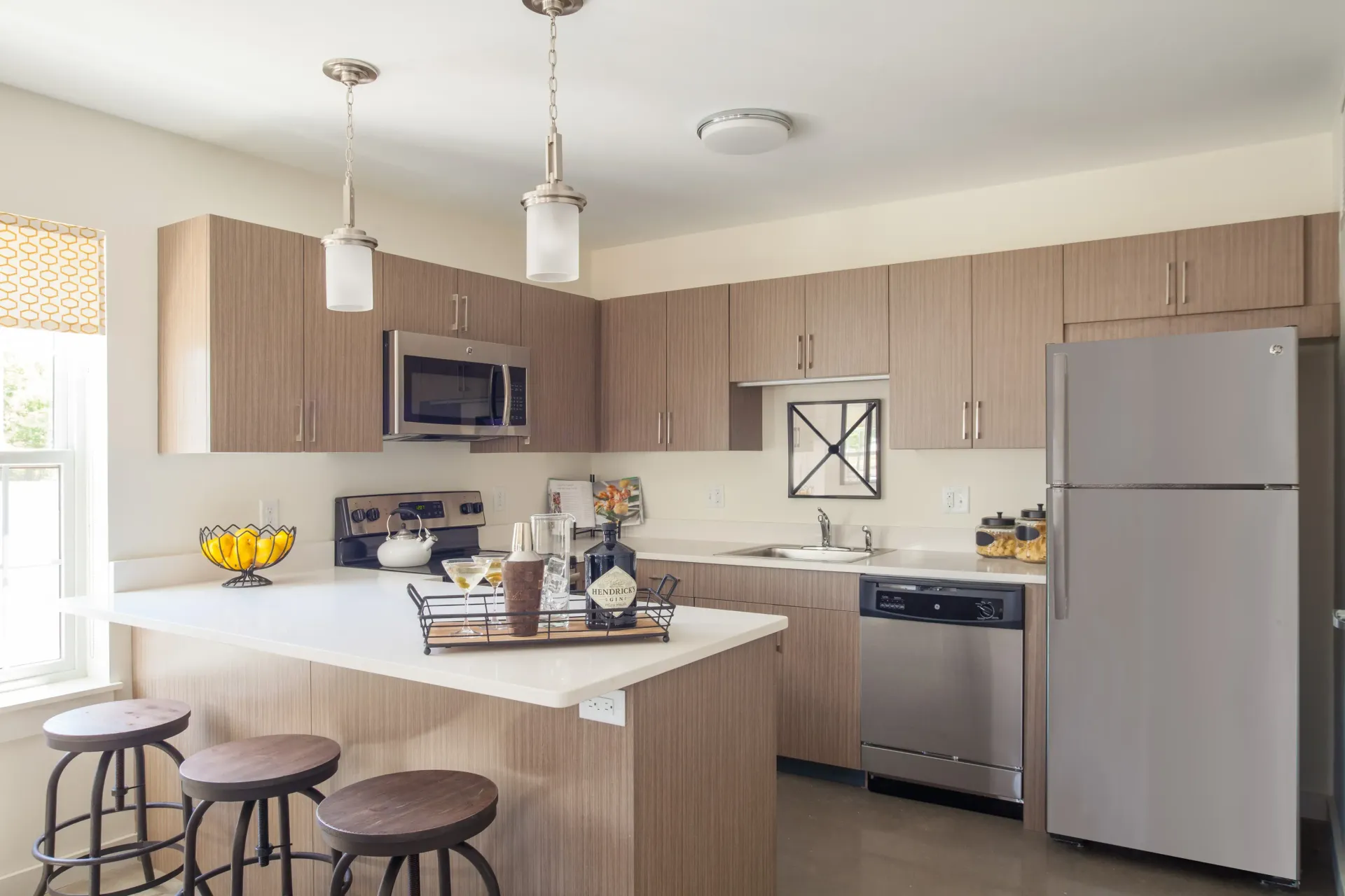 McKay apartment kitchen with modern cabinets, appliances, and oversized bar.
