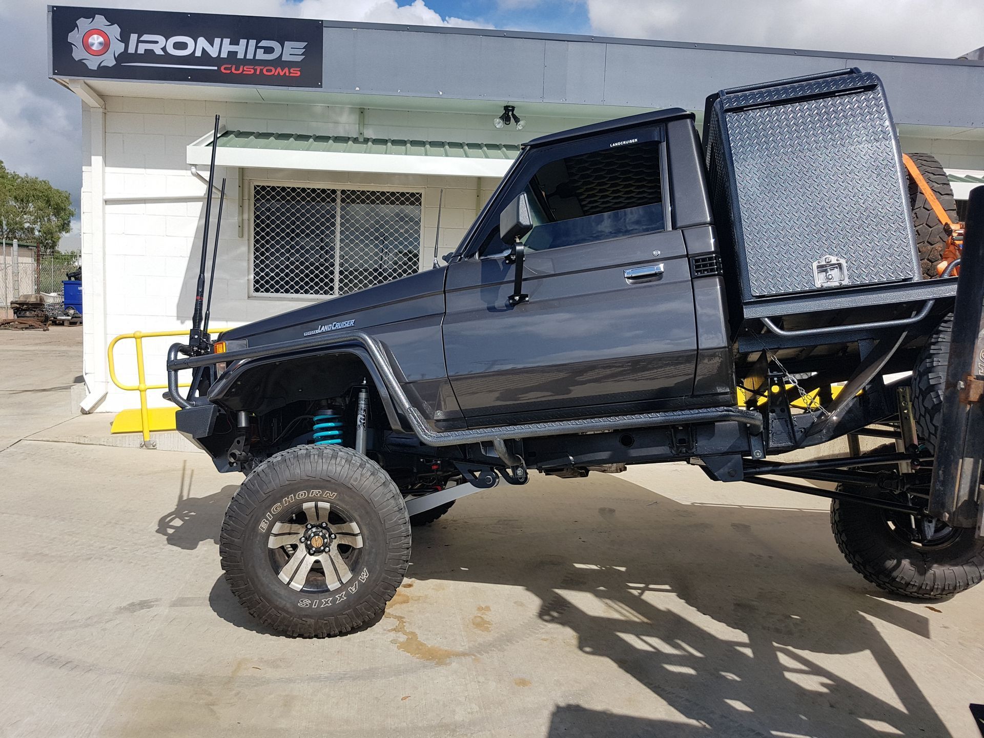 A Black Lifted Pickup Truck with A Large Diamond-Plate Storage Box — Ironhide Customs In Garbutt, QLD