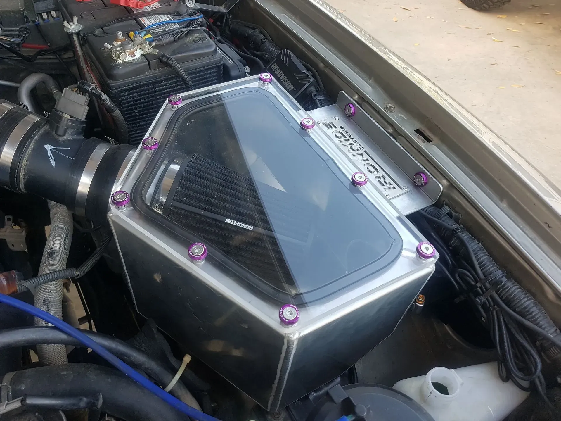 Clear plastic automotive air intake box with a filter in an engine bay — Ironhide Customs In Garbutt, QLD