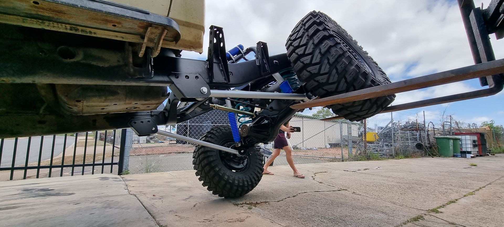 A Low-Angle View of A Lifted Off-Road Vehicle’s Suspension System — Ironhide Customs In Garbutt, QLD