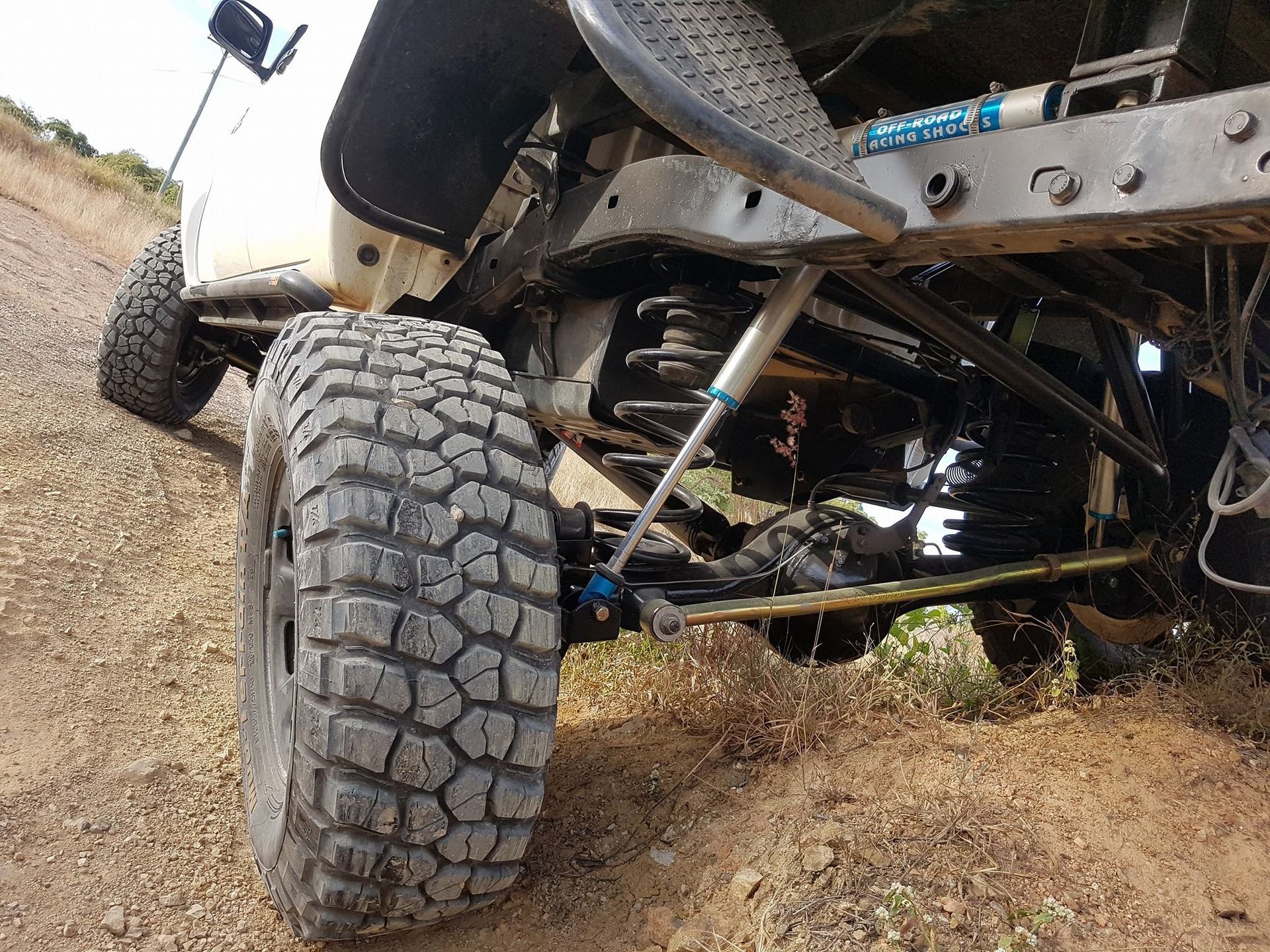 Off-road Truck Suspension and Tire on a Dirt Trail, Viewed From Below — Ironhide Customs In Garbutt, QLD