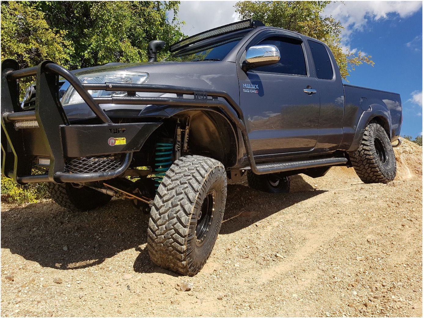 A Dark Gray Pickup Truck with Off-Road Modifications — Ironhide Customs In Garbutt, QLD