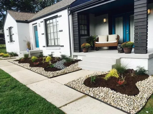 A white house with a blue door and a couch on the porch