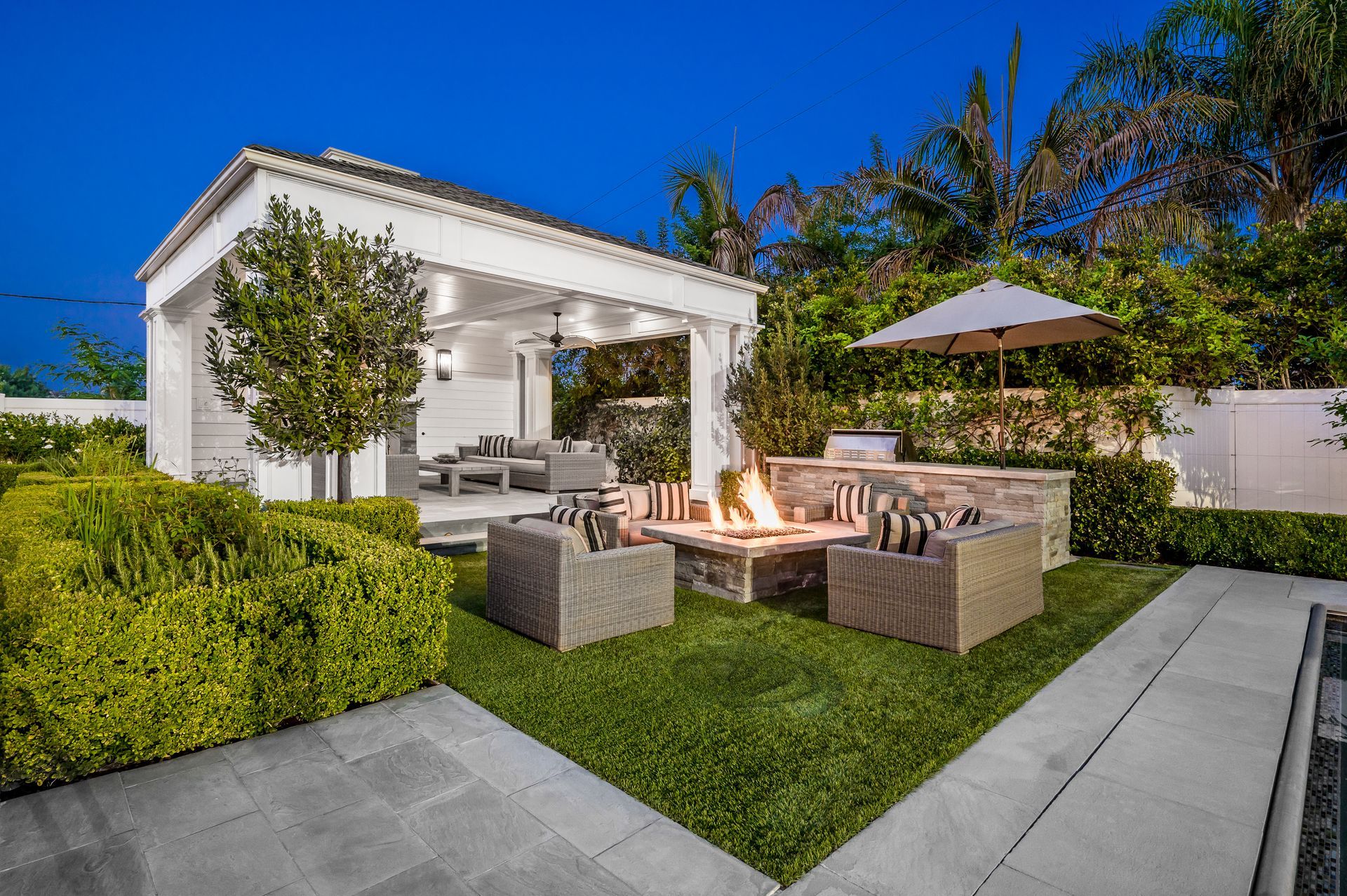 There is a fire pit in the middle of the backyard.