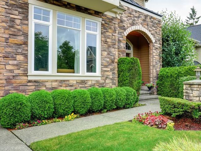 A large house with a large lawn in front of it.