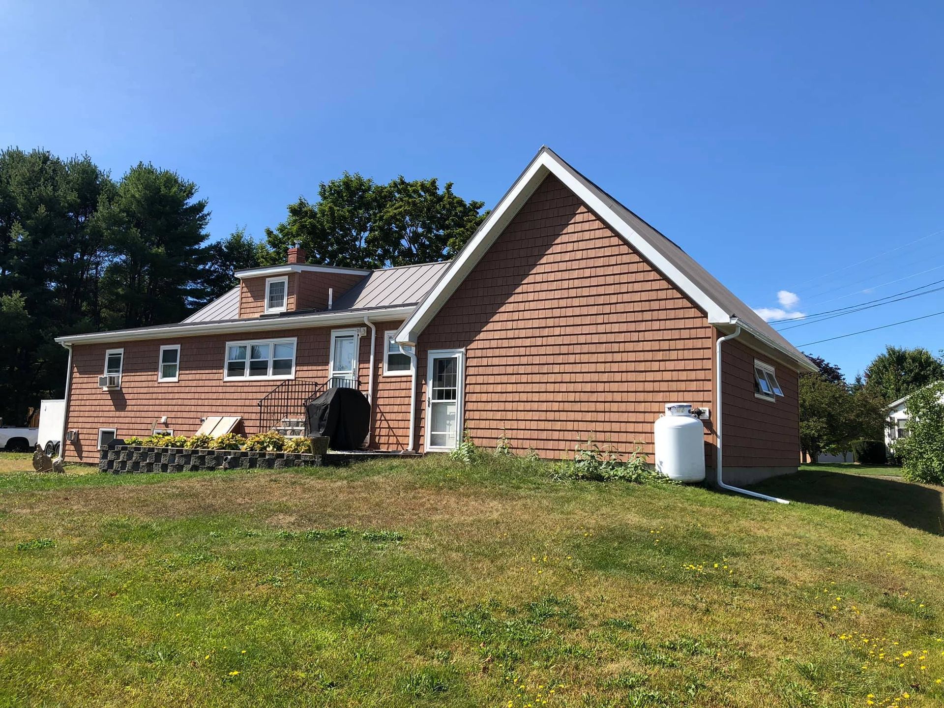 Rear View of Home in Lewiston, ME With Updated Roof and Siding