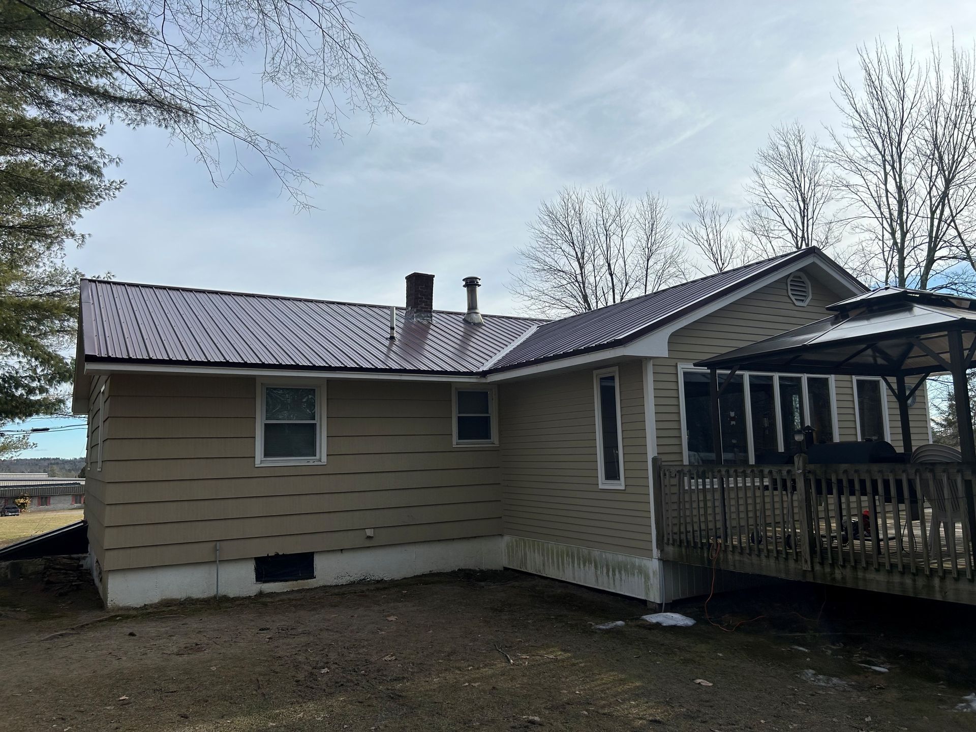 Rear View of Home With Metal Roofing Surface