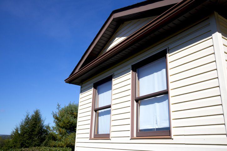 House with pale yellow vinyl siding