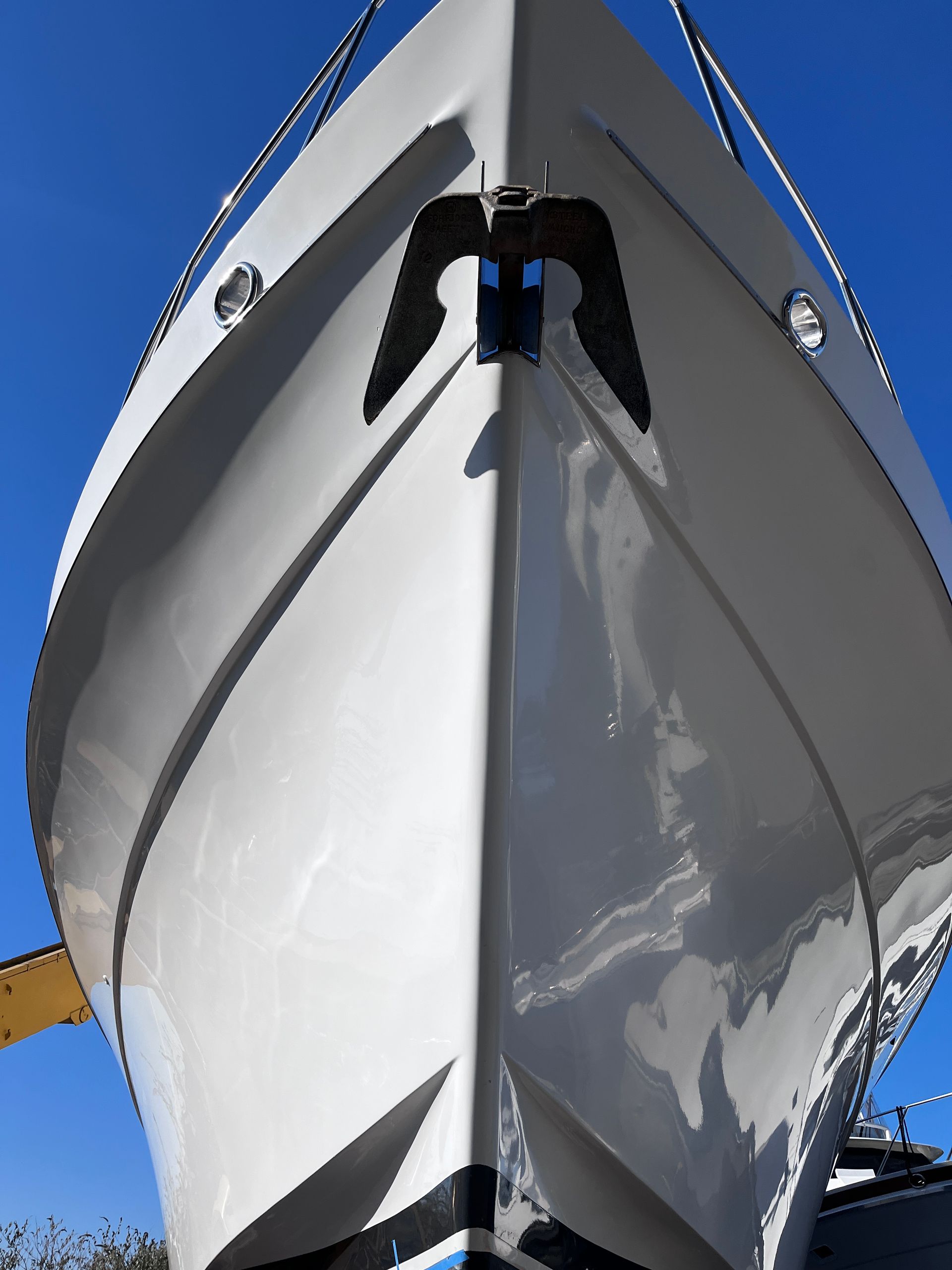 A white boat with a black bird on the bow