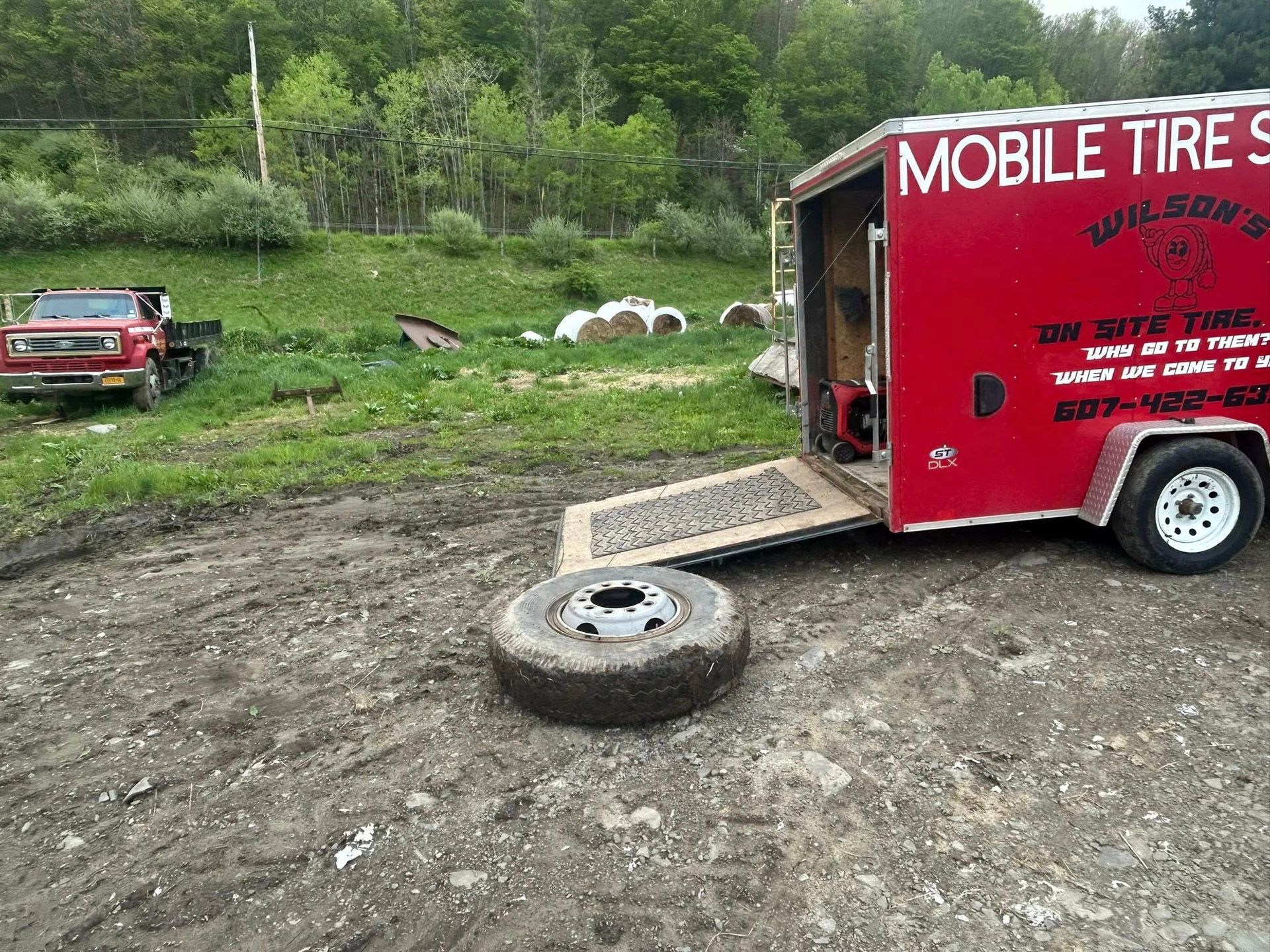 A red trailer with the word mobile tires on it