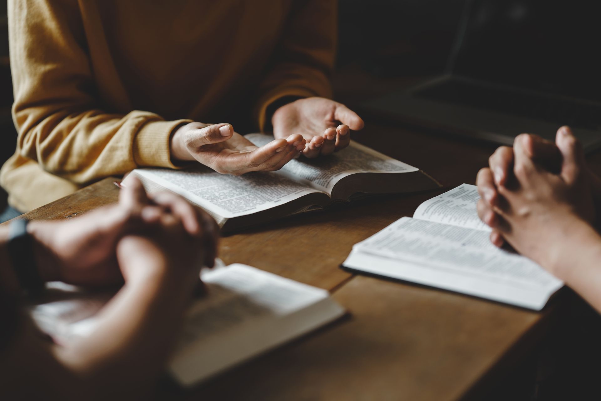 People studying together around a table with open books and notebooks