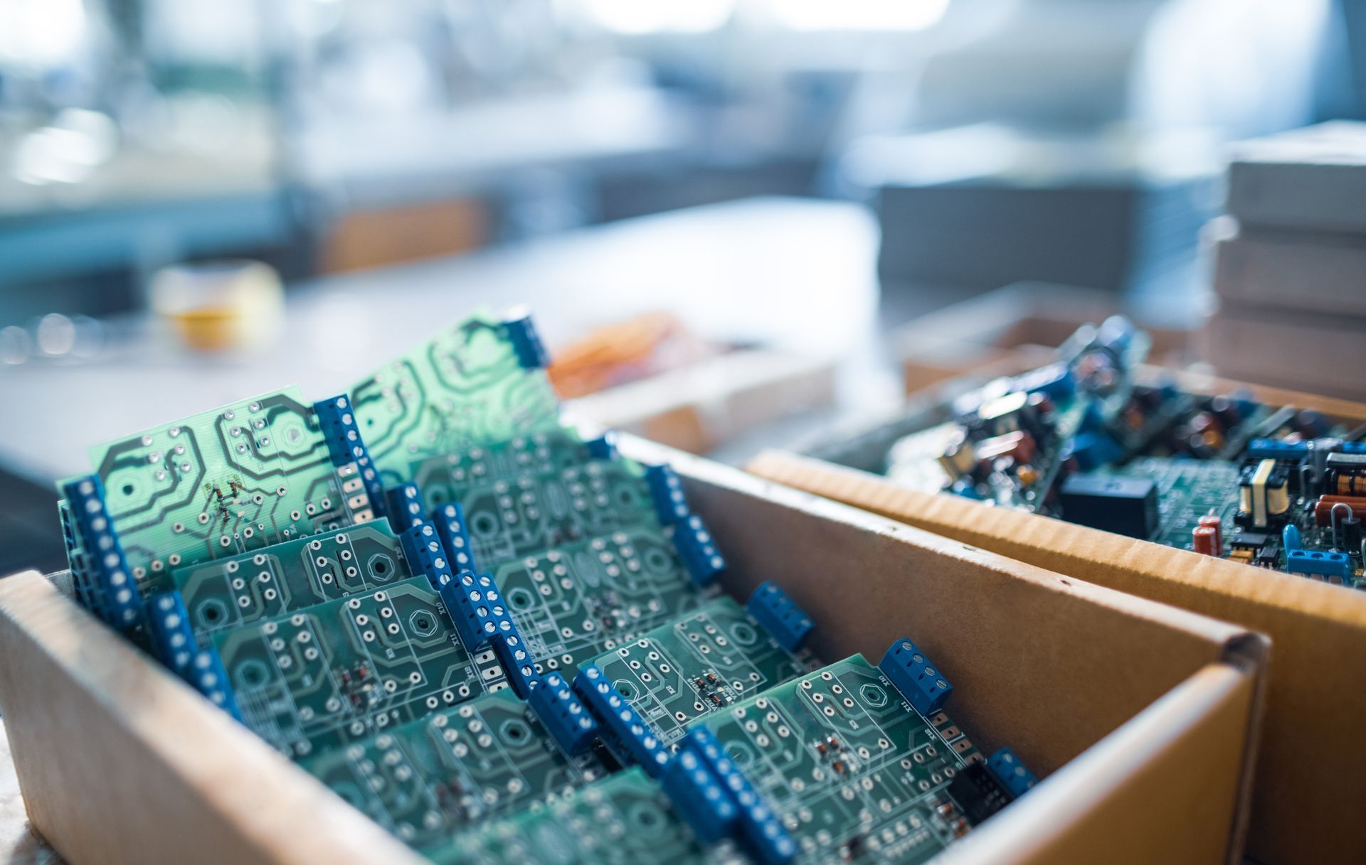 A box filled with electronic components is sitting on a table.