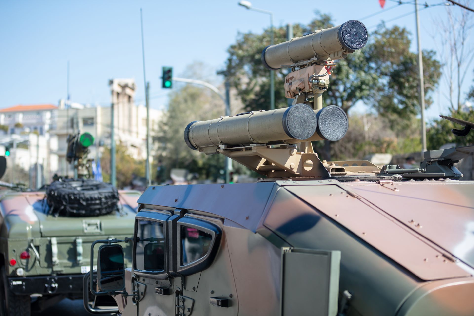 A military vehicle is parked on the side of the road.