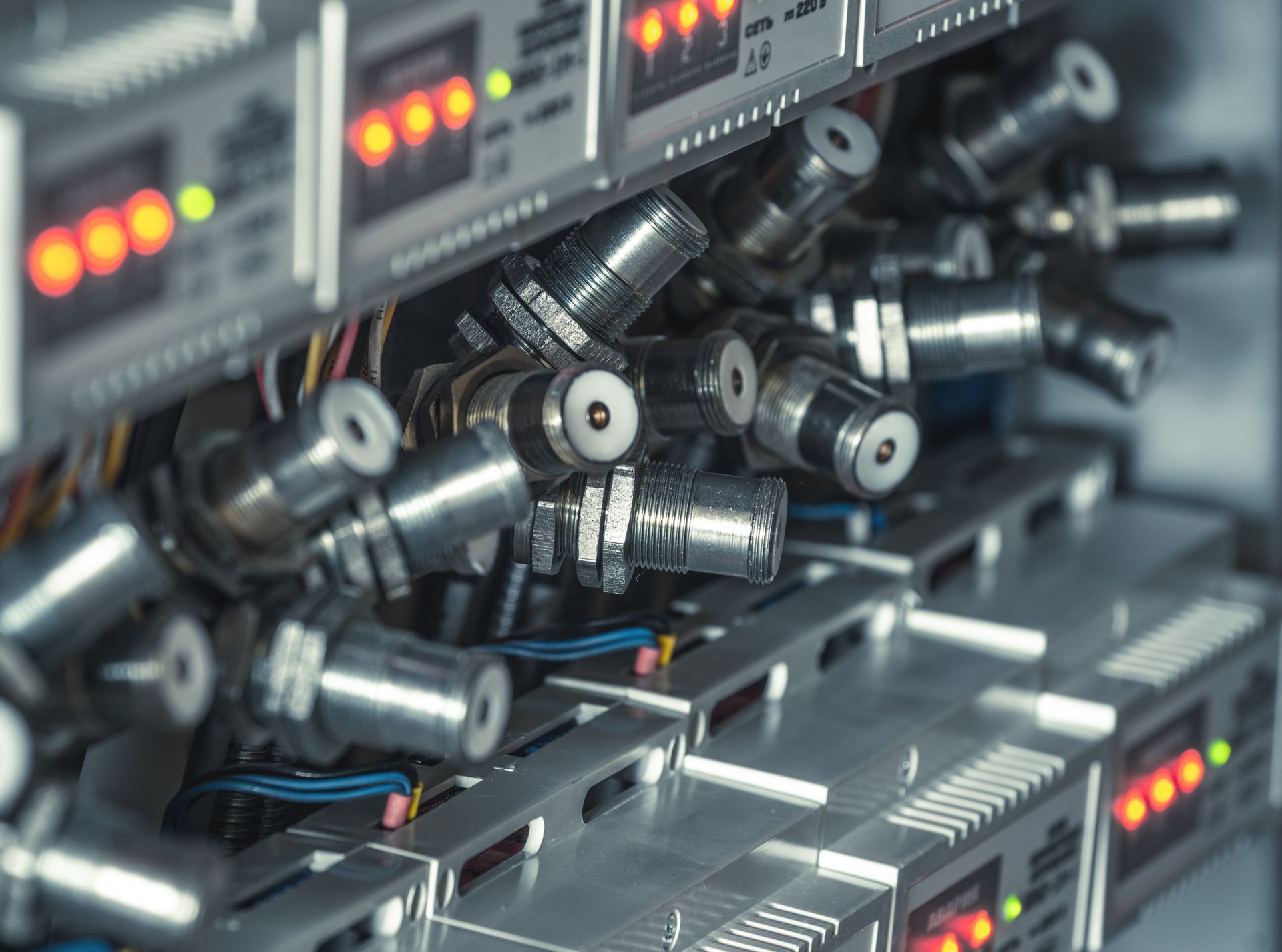 A bunch of microscopes are sitting on top of each other in a server room.