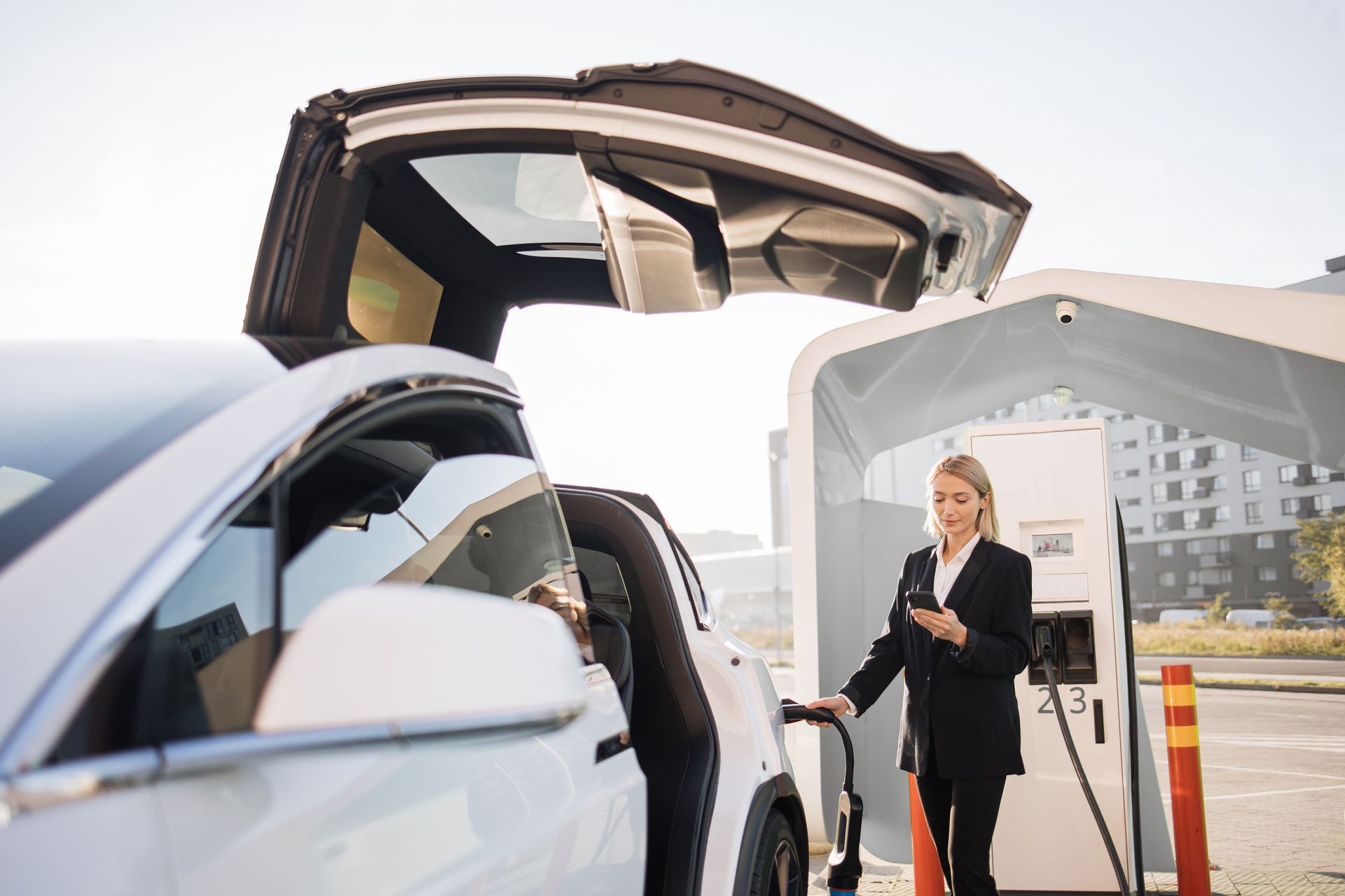 woman charging her electric vehicle 