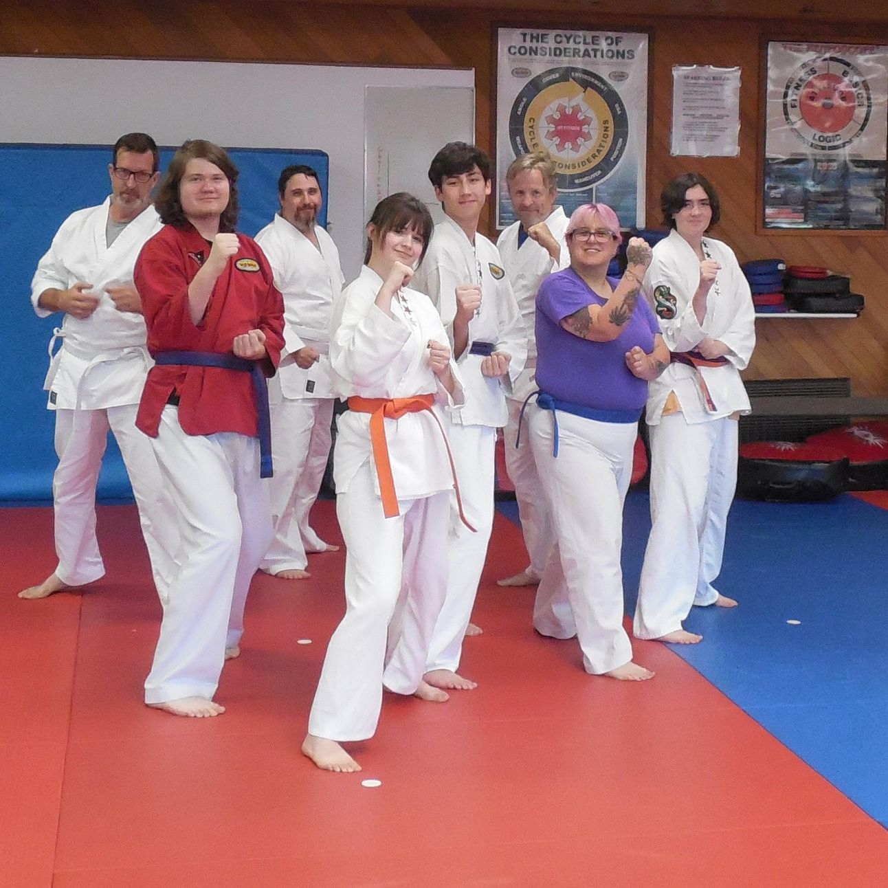 A group of people in karate uniforms are posing for a picture
