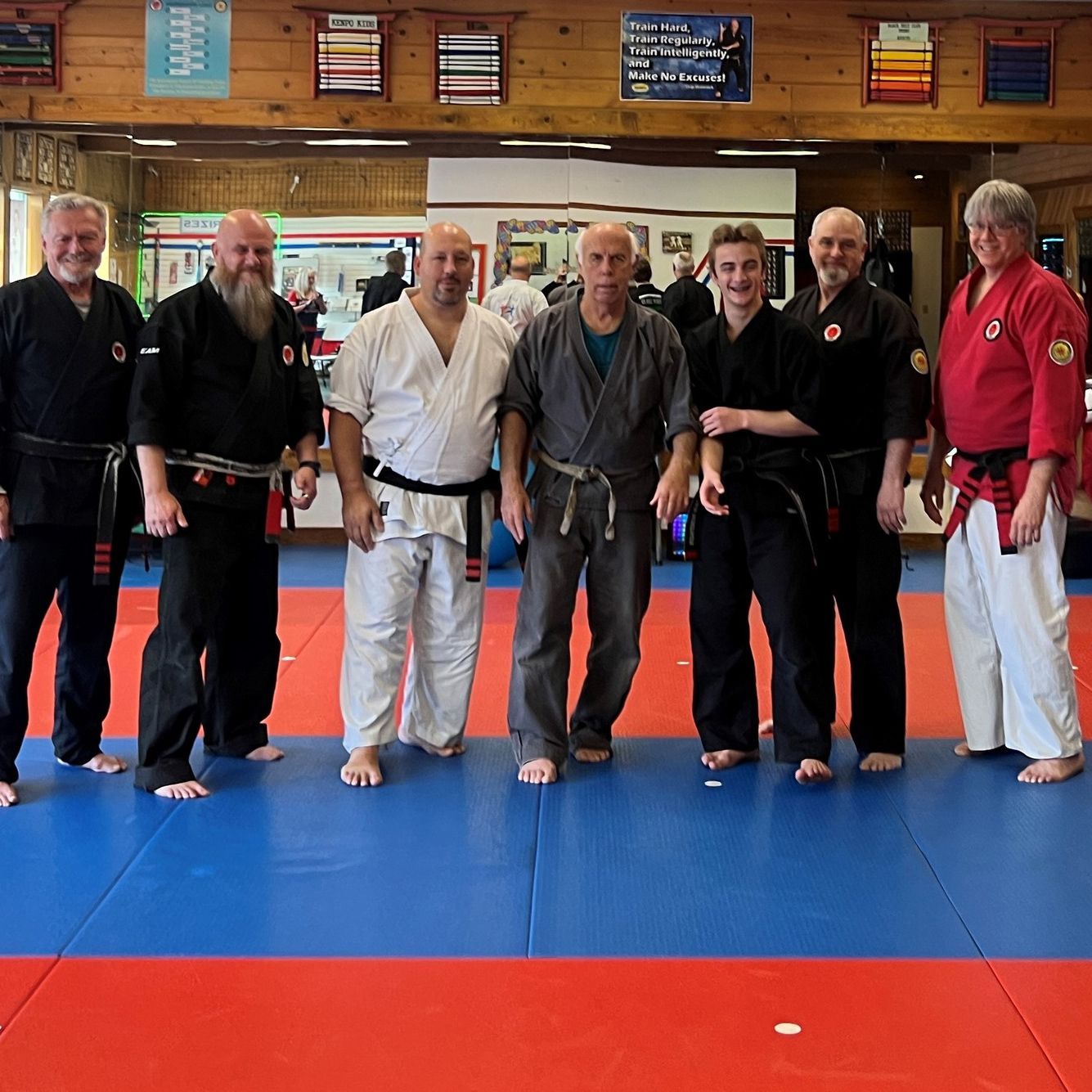A group of men are posing for a picture in a gym