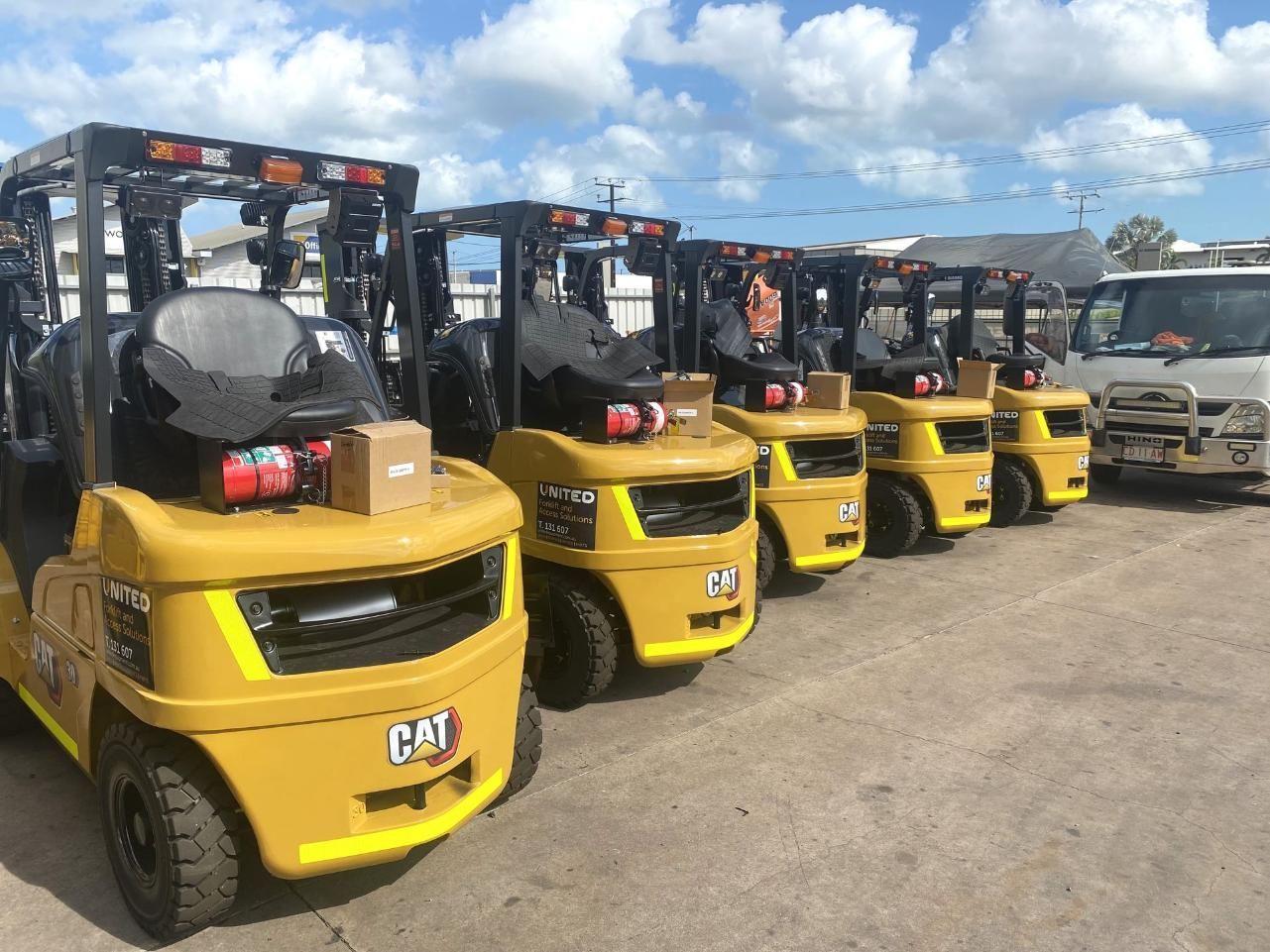 A Row of Yellow Forklifts Parked Next to Each Other in A Parking Lot — Advanced Weighing Technology NT Pty Ltd In Winnellie, NT