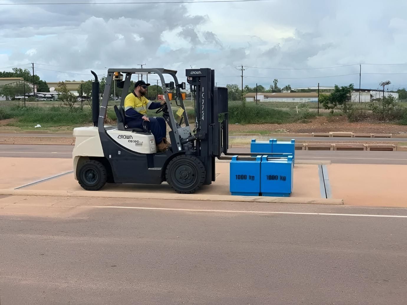Two Men Are Driving a Forklift Down a Road — Advanced Weighing Technology NT Pty Ltd In Winnellie, NT