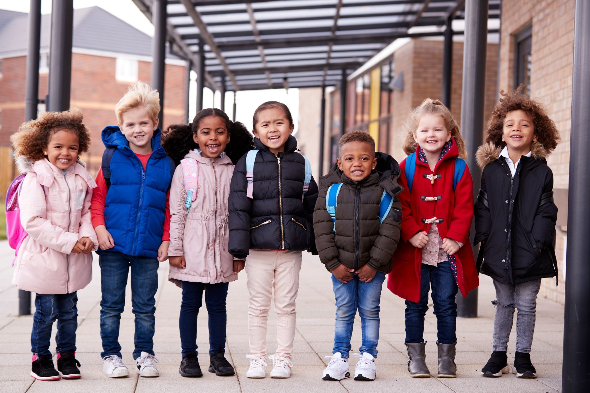 group of smiling you multi-eithnic children at school