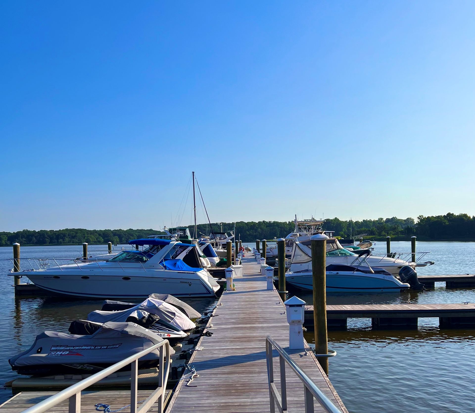 Boats are docked at a marina on a sunny day