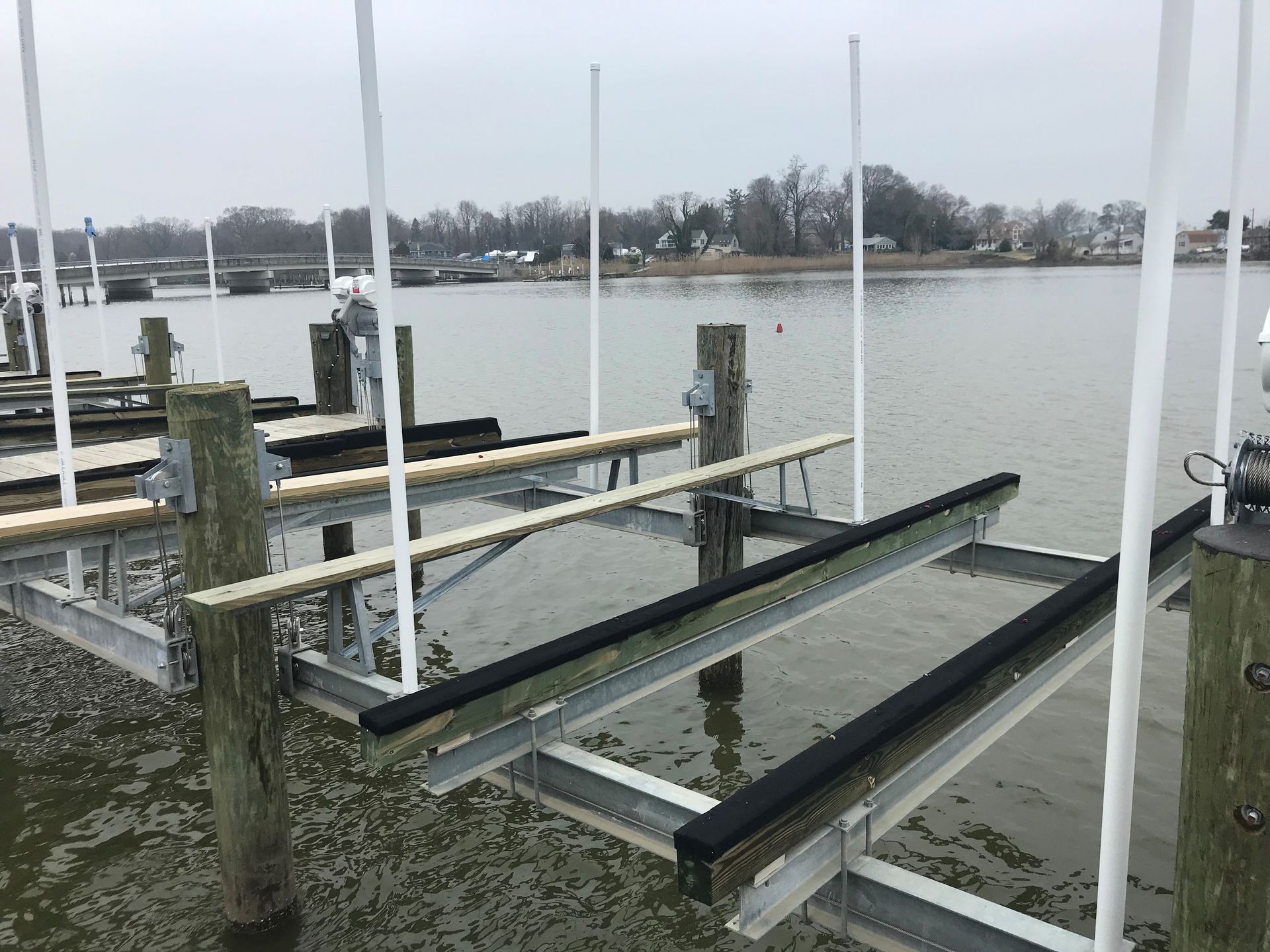 A boat lift is sitting in the middle of a body of water.