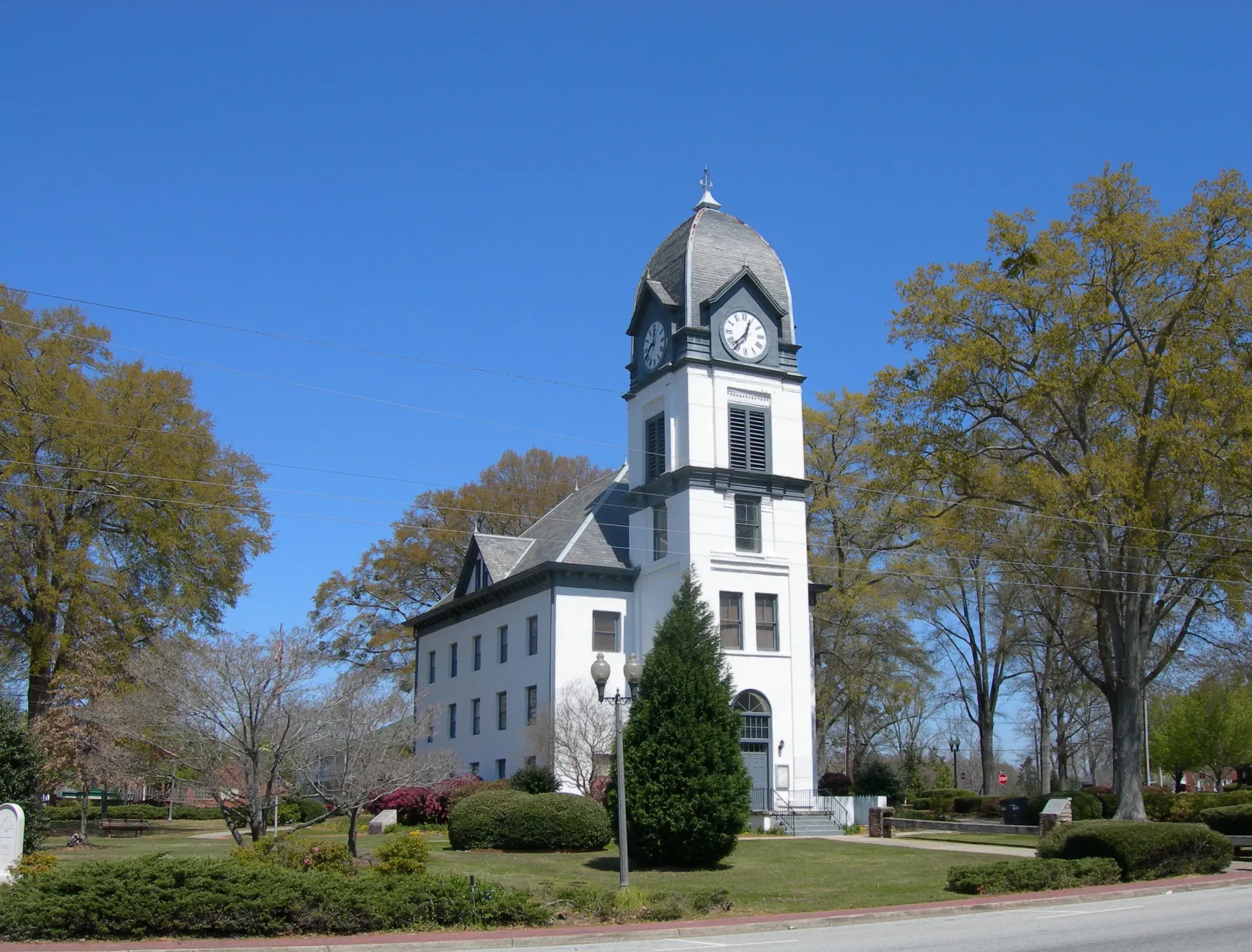 A large white building with a clock tower on top