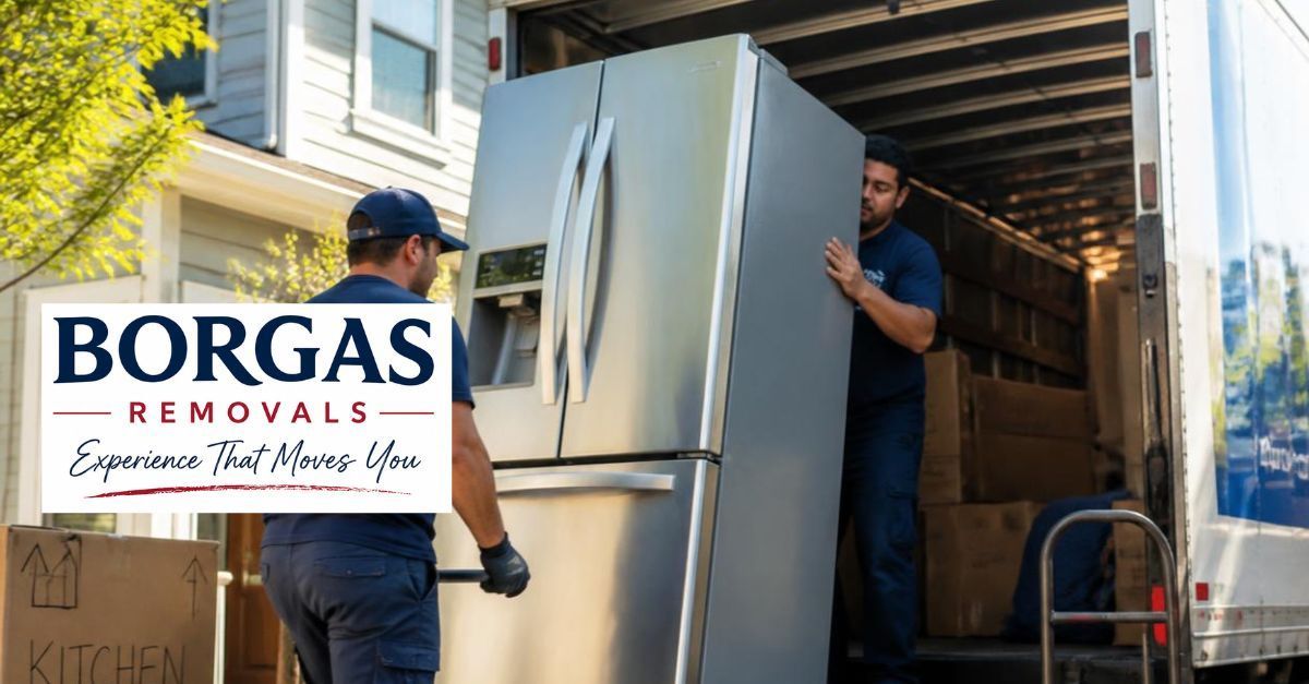 Borgas Removals safely loading a stainless steel refrigerator into a removal truck for a house move.
