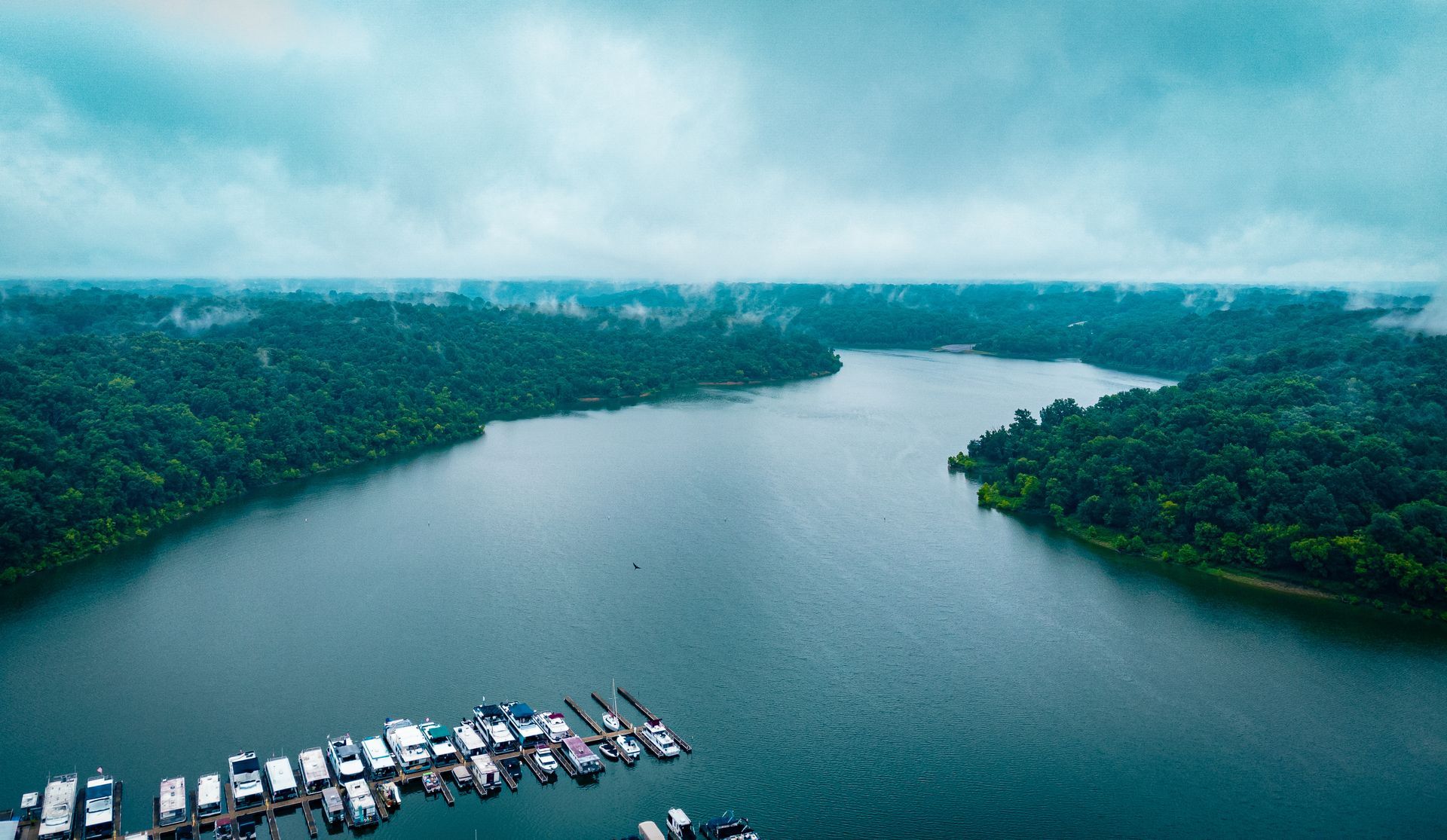 An aerial view of a large body of water surrounded by trees.