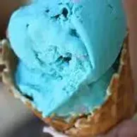 Blue ice cream scoop in a waffle cone, close-up