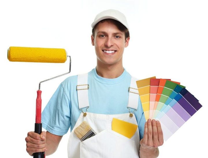 A Man is Holding a Paint Roller and a Palette of Colors — Painting Services in Rockhampton, QLD
