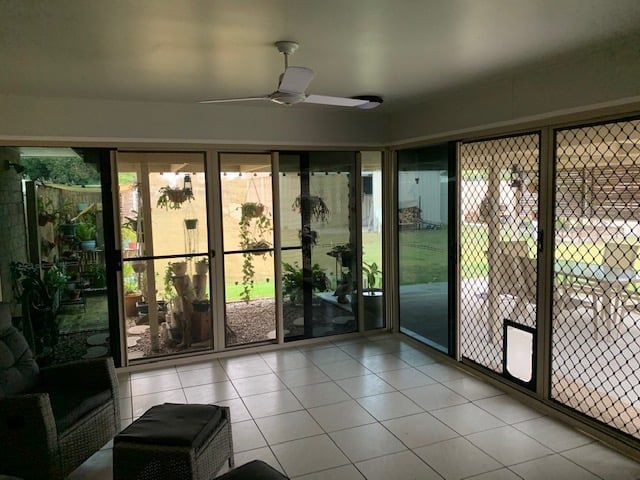 Living Room With Sliding Glass Doors — Moore Park Beach Glass & Security in Moore Park Beach, QLD