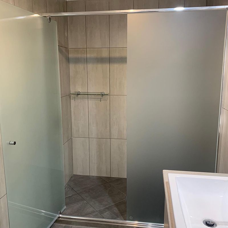 Bathroom With a Sliding Glass Shower Door and a Sink — Moore Park Beach Glass & Security in Bundaberg, QLD