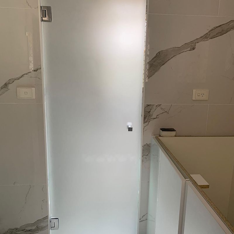 Bathroom With a Bathtub and a Frosted Glass Door in — Moore Park Beach Glass & Security in Agnes Water, QLD