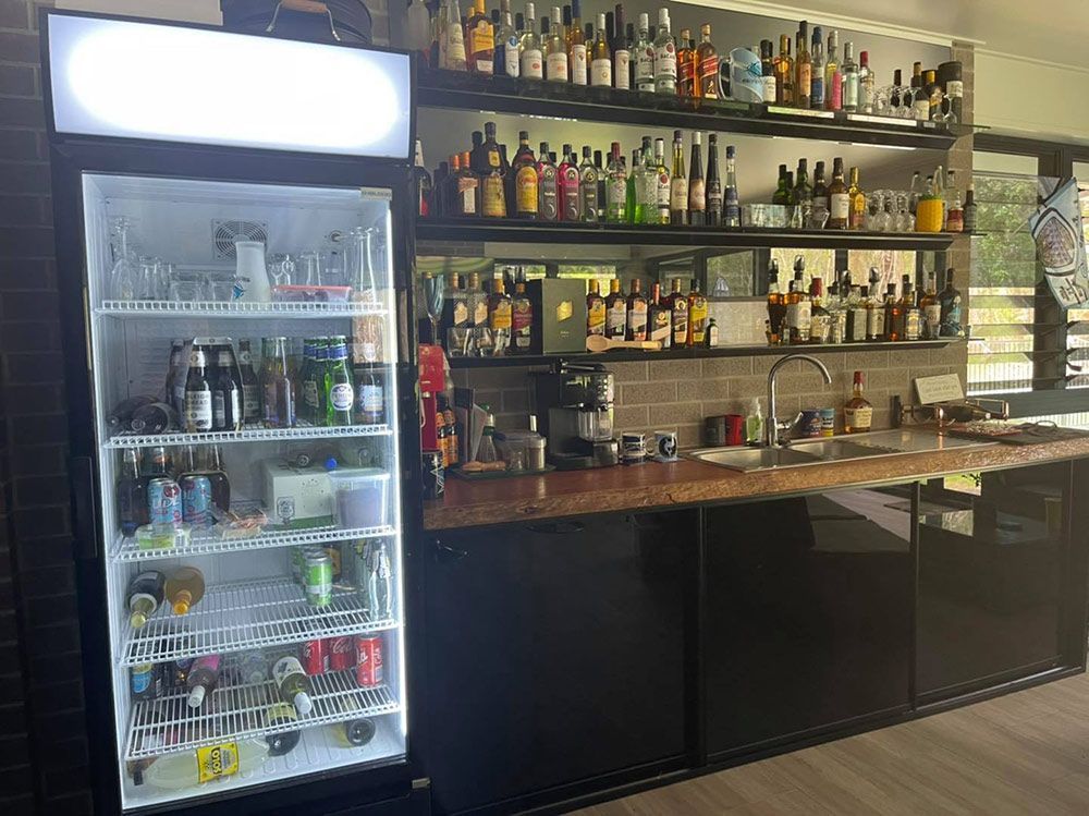 Kitchen With Splashback and a Refrigerator — Moore Park Beach Glass & Security in Childers, QLD