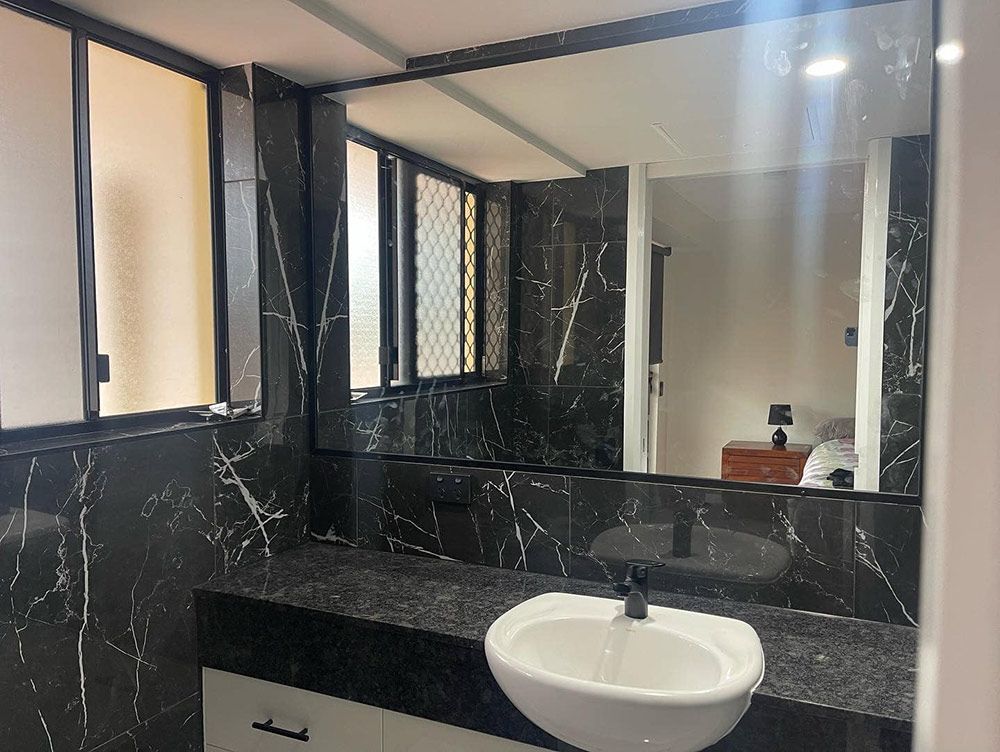 Bathroom With a Sink And a Large Mirror — Moore Park Beach Glass & Security in Moore Park Beach, QLD