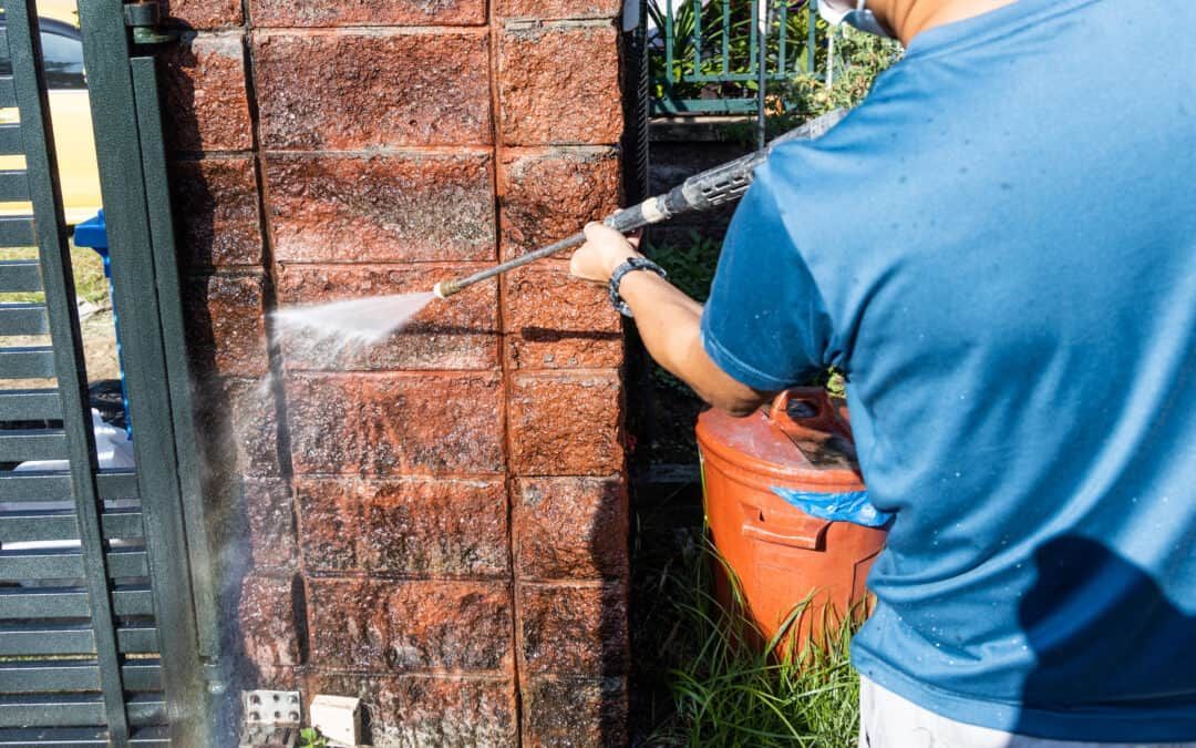 Homeowner performing a DIY exterior cleaning project at a Windsor residence.