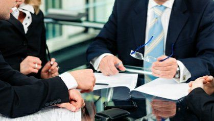 A group of people discussing a business transaction.