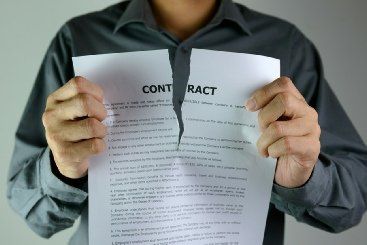 A man tearing up a business contract.