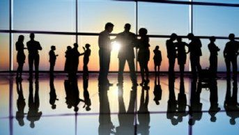 Group of professionals engaged in business formation discussions  in a modern law office.