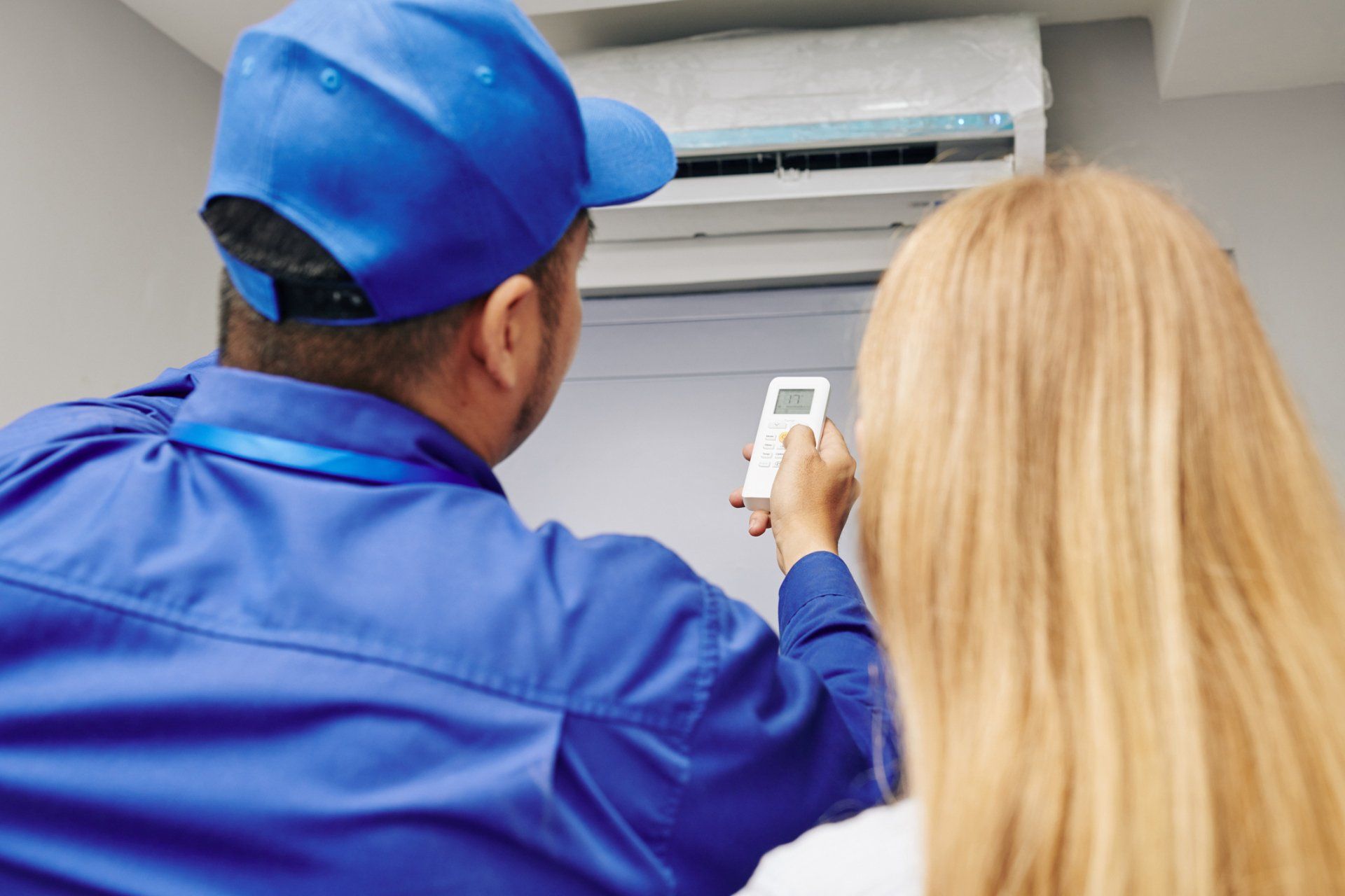 Service Worker Using Remote Control - Hendersonville, NC - Tucker Heating & Air