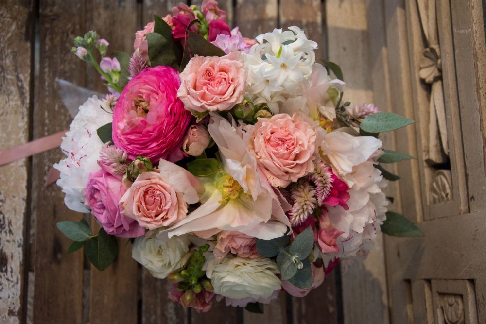 A Bouquet of Pink and White Flowers Is Sitting on A Wooden Table — Pick-A-Bunch Florists & Gifts In Sarina, QLD