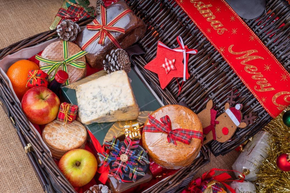 A Wicker Basket Filled with Christmas Food and Decorations — Pick-A-Bunch Florists & Gifts In Hay Point, QLD