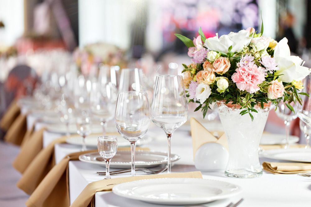 A Table Set with Plates, Glasses, and A Vase of Flowers — Pick-A-Bunch Florists & Gifts In Sarina, QLD