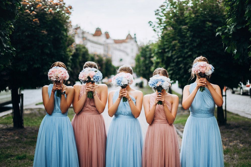 A Group of Bridesmaids Standing Holding Bouquets of Flowers — Pick-A-Bunch Florists & Gifts In Sarina, QLD