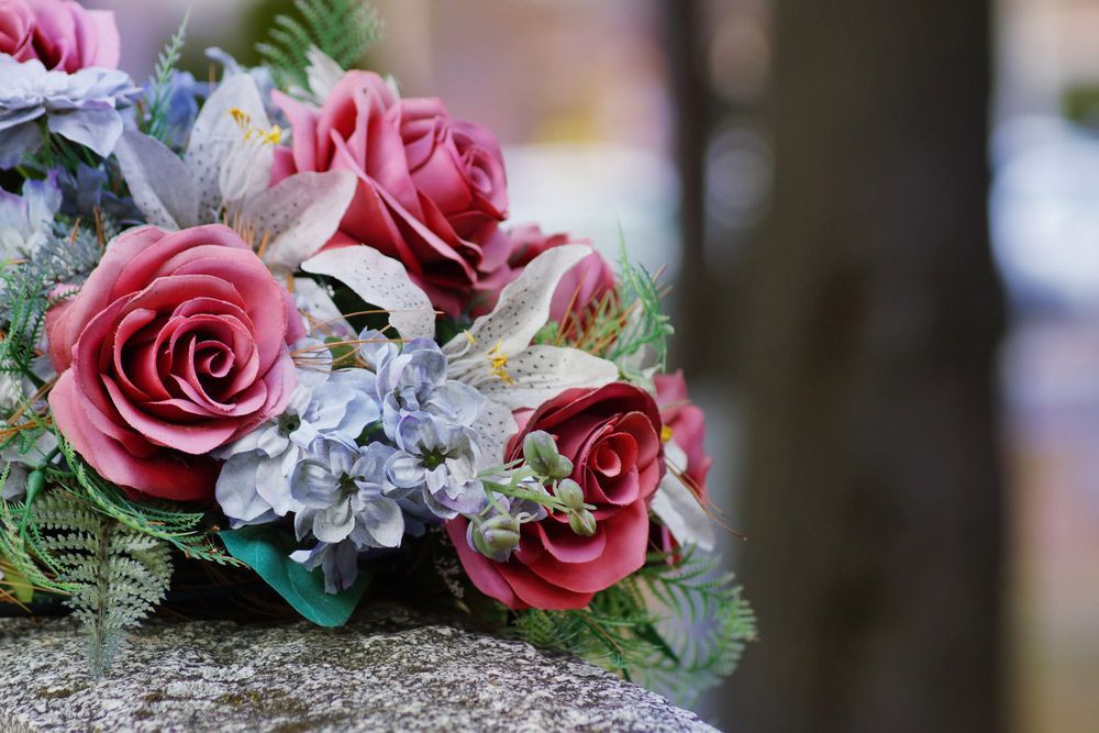 A Bouquet of Flower Is Sitting on Top of A Rock — Pick-A-Bunch Florists & Gifts In Armstrong Beach, QLD
