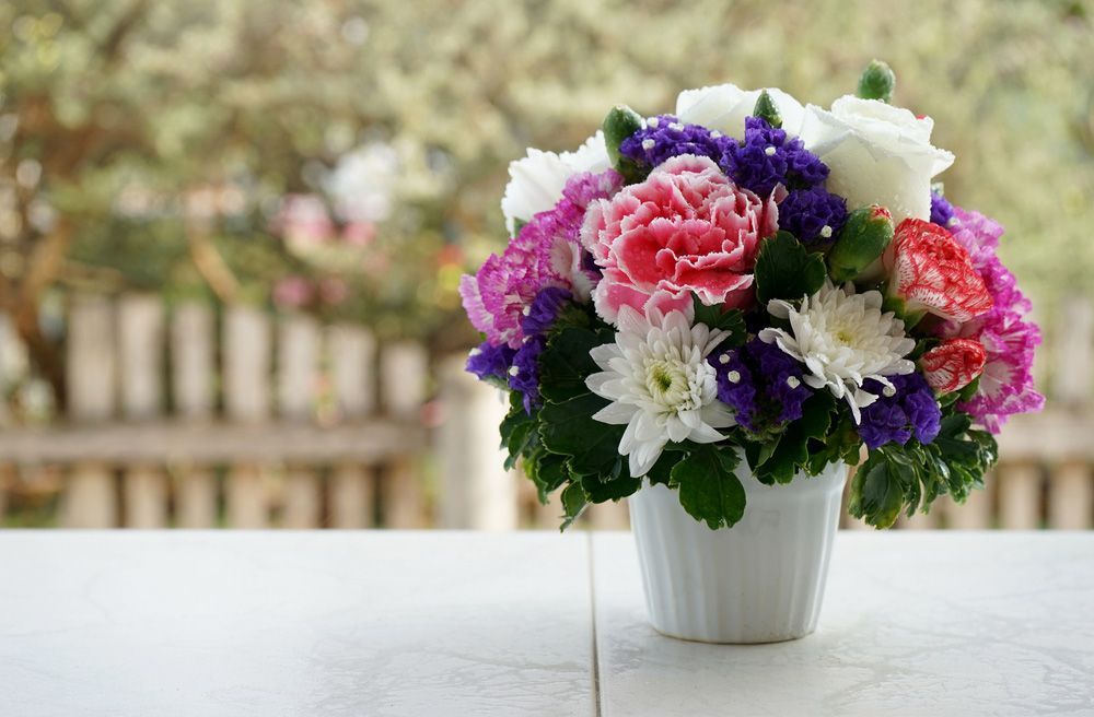 A Vase Filled with Flowers Is Sitting on A Table — Pick-A-Bunch Florists & Gifts In Koumala, QLD