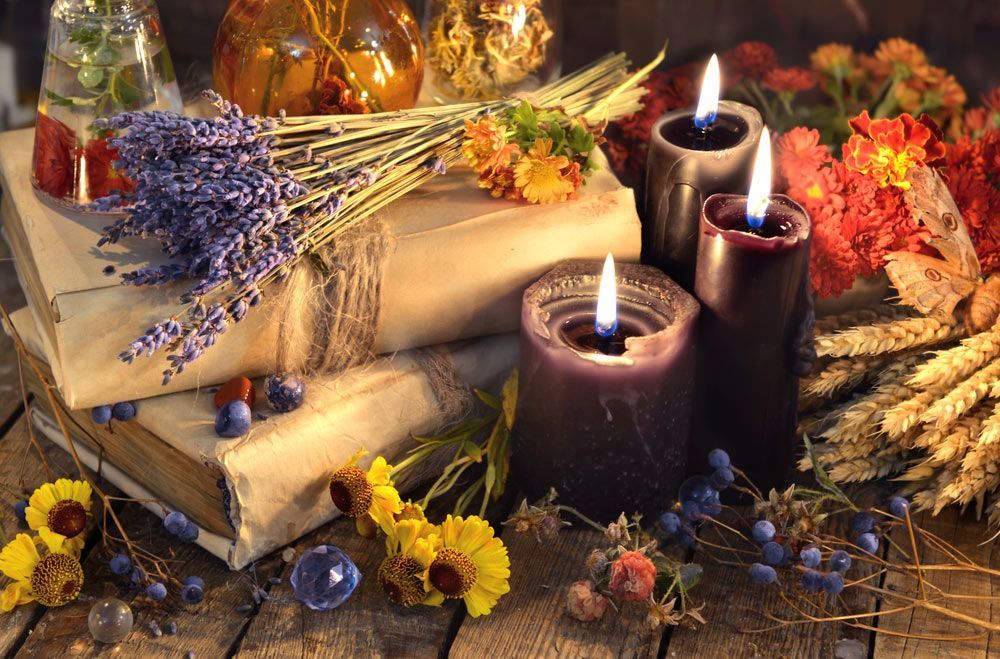 A Wooden Table Topped with Books, Candles, Flowers and Other Items — Pick-A-Bunch Florists & Gifts In Koumala, QLD