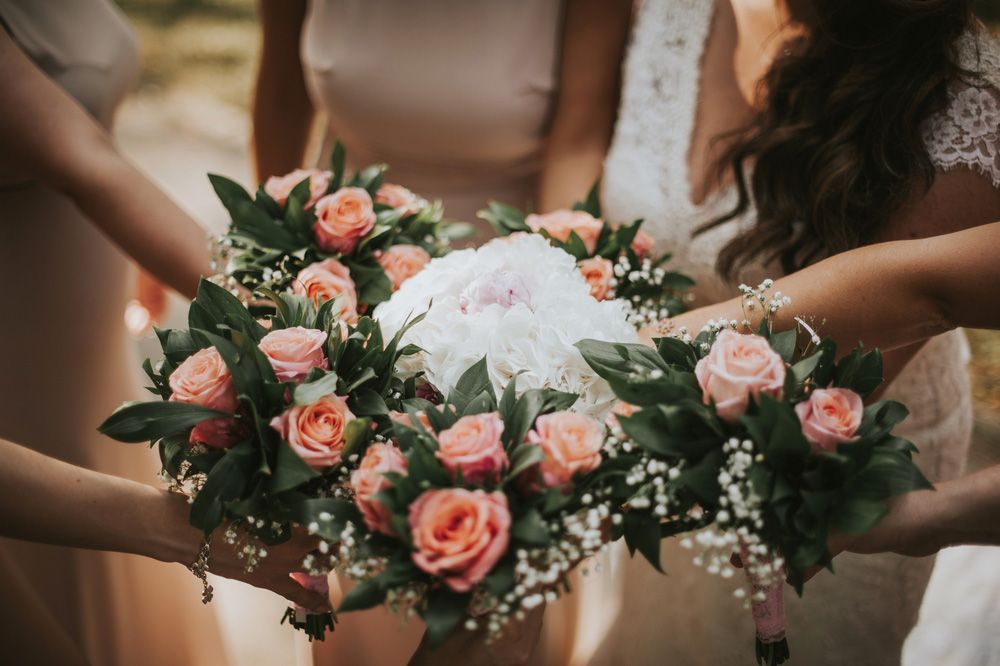 A Bride and Her Bridesmaids Are Holding a Bouquet of Flowers in Their Hands — Pick-A-Bunch Florists & Gifts In Sarina, QLD