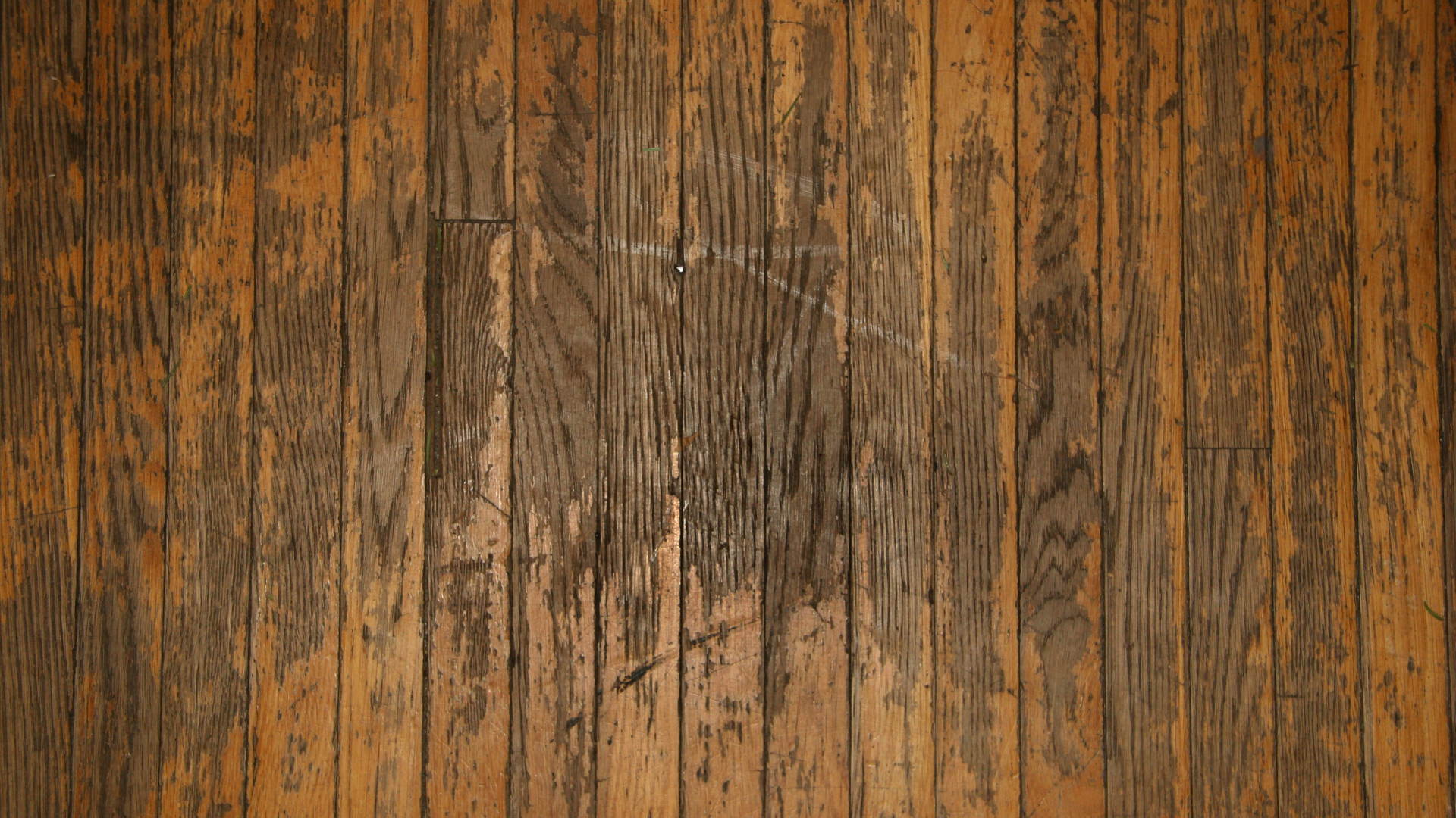 Scratched hardwood floor restoration and professional hardwood floor refinishing repair creating a renewed wood surface